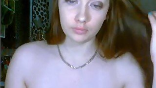 Redhead plays with her big tits on webcam