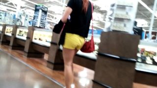 Sexy shopper with a luscious ass in bright yellow shorts is