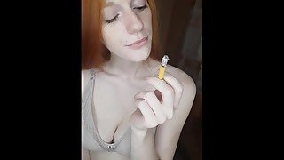 redhead girl smokes a cigarette