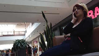 Mature woman sitting on mall bench