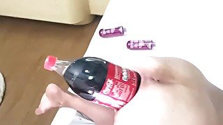 Big soda bottle is penetrating her tight asshole