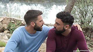 Bearded gay couple enjoy each others dicks outdoors by the river