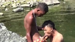 Teen gay swimmer playfully going down in the river