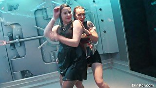 Two sluts are dancing and touching each other under the shower in one night club