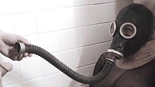 Crazy chick in a gas mask swallows a ton of pee