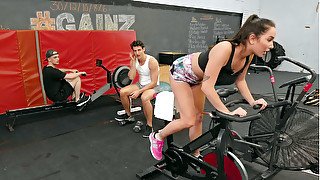 Karlee Grey rides a bike in the gym and flashes her pussy