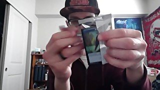 Cute Nerd Opening a Pack of Magic The Gathering Cards