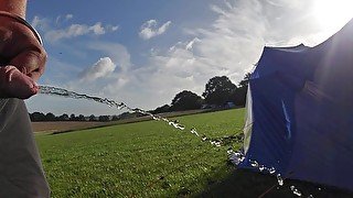 Pissing on a camp field in the morning