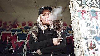 Blonde lady smokes an electronic cigarette