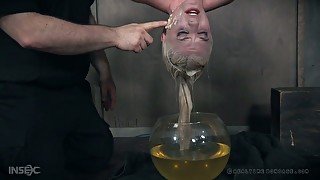 Pale short haired auburn slut Dresden is tied up and put into fish globe