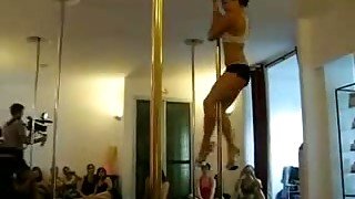 Tasty looking brunette chic moves seductively on a pole