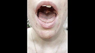 A nice blondie is coughing and spitting close up