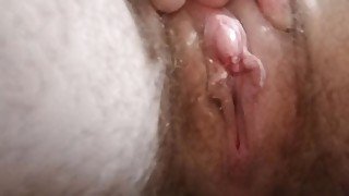 Close-up of pussy and large clit while pissing