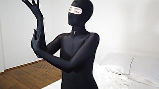 Mary Rock posing in a black ninja costume