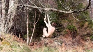 Naked self-bondage in the woods gone wrong.