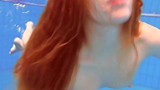 Redhead Katka playing underwater