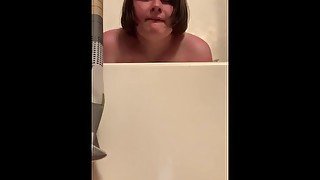 Girl rides her hand in bathtub until she cums