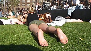 Cute Blonde Sunbathing Her Naked Soles And Feet On The Local Square