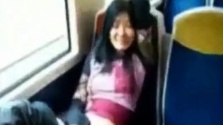 Asian milf rubs her clit on a train.