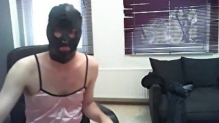 Gay man in women's clothing and leather mask jerks off cock and cums in panties