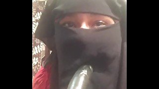 Lonely Niqabi Hijabi woman sucking dildo & shaking ass