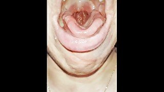 A blondie teen has a really bad cough shes coughing and spitting with mouth and throat open close up