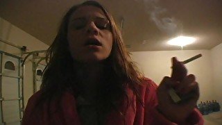 Teenager in bathrobe smokes sensually