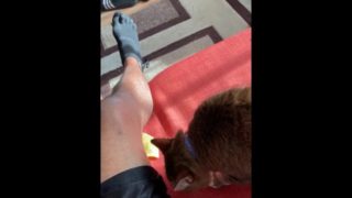 Cat licking chip by my leg