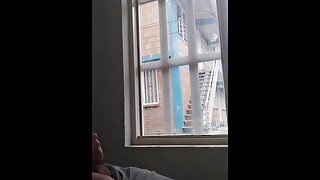 masturbating in the window facing the street