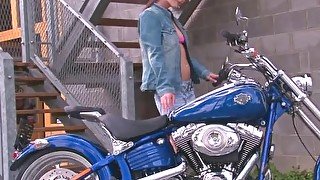 Hot motorcycle babe strips for the camera