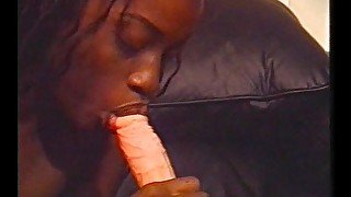 Ebony slut fucks herself with a white dildo