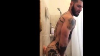 Tatted Hunk Fucks Dildo in Shower Until He Cums