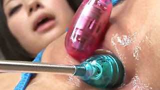 Well shaped Asian cutie gets her wet shaved cunt stimulated with a couple of dildos