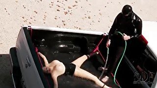 Daring babe in full body latex suit gets submerged in water