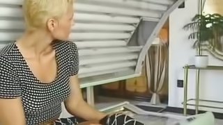 Busty short-haired blond milf enjoys sex in a solarium