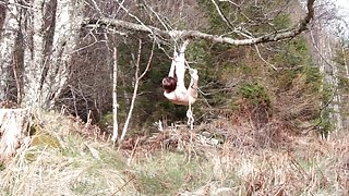 Naked self-bondage in the woods gone wrong.