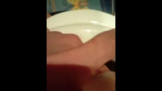 Girl masturbates while sitting on the toilet