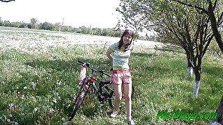 Peeing on her bicycle