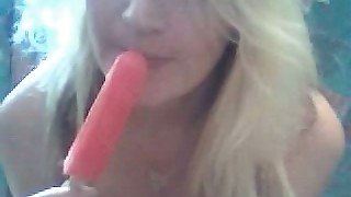 Blonde cutie sucks a popcicle and rubs her clit with it