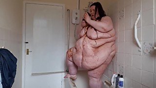 Ssbbw body covered in chocolate sauce in shower