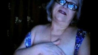 Russian granny ex-teacher flashing her big tits on  webcam