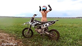 Naked woman riding a Dirt Bike