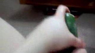 Slut takes huge cucumber in her pussy