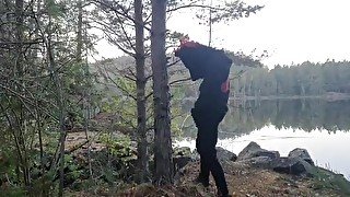 Fursuiter taking a piss against a tree