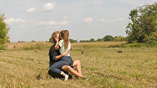 Beautiful Teen Couple in Love Passionately Kissing on the field