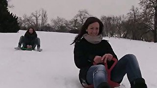 Two cute girls on a sled