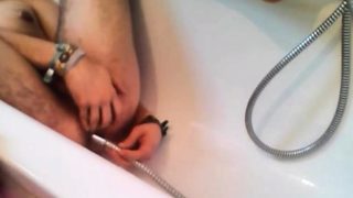 Bi-guy using shower head, squirting water, enema