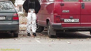 Girl peeing between the cars