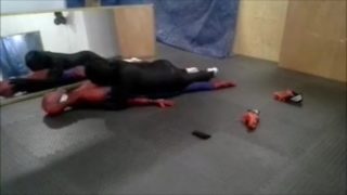 black sex drone playing with his spiderman dummy