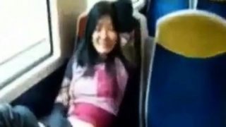 Asian milf rubs her clit on a train.